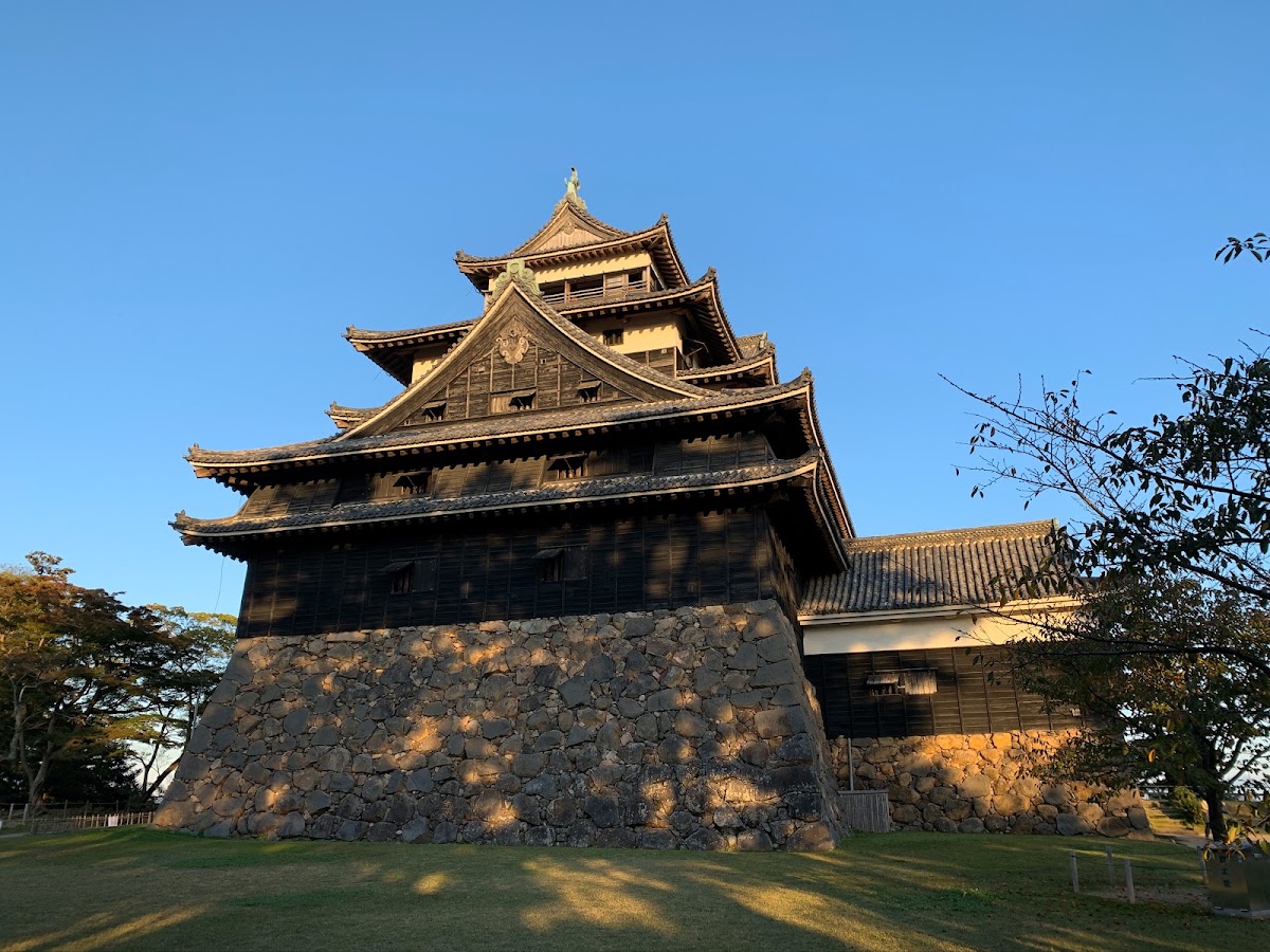 Black wooden keep of Matsue Castle above the moat